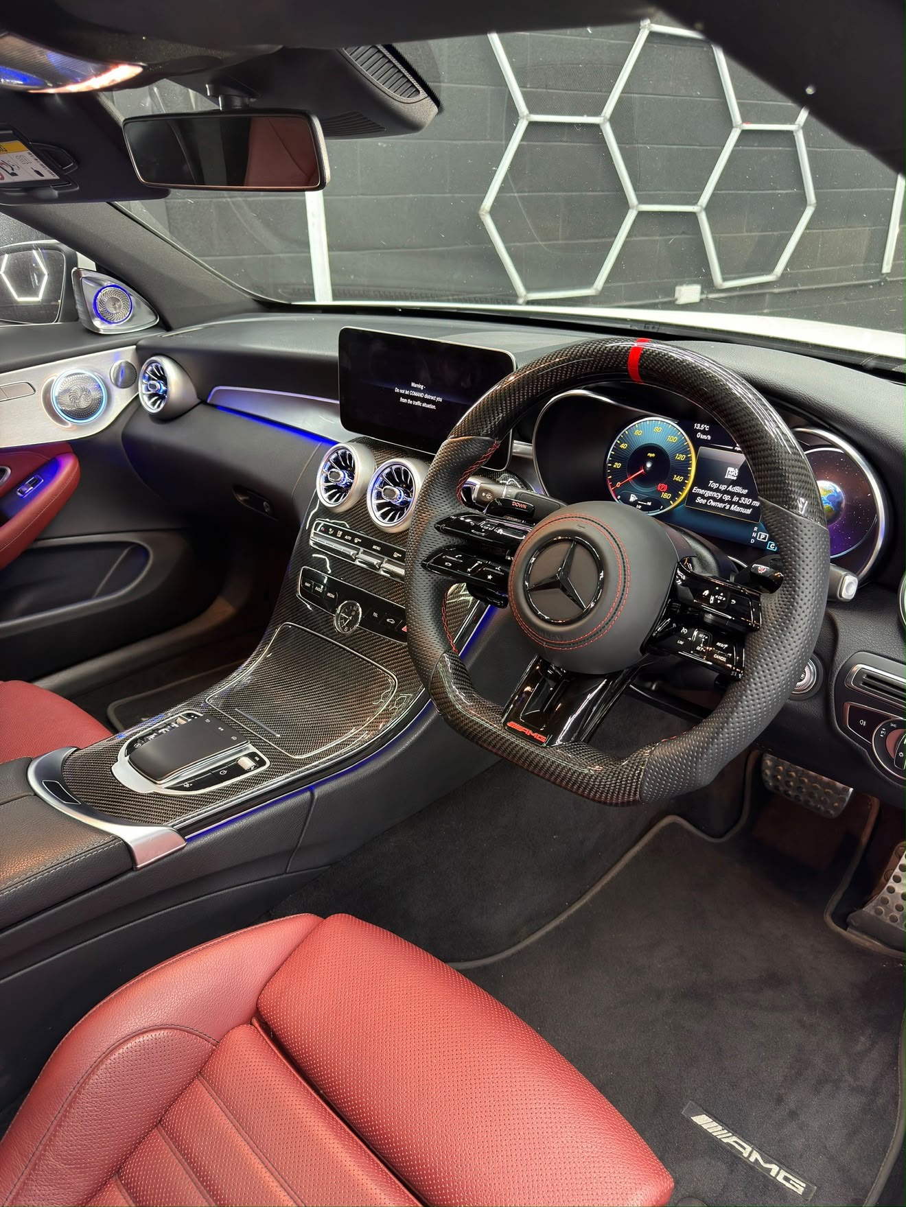Mercedes-AMG interior with carbon trim and blue ambient lighting